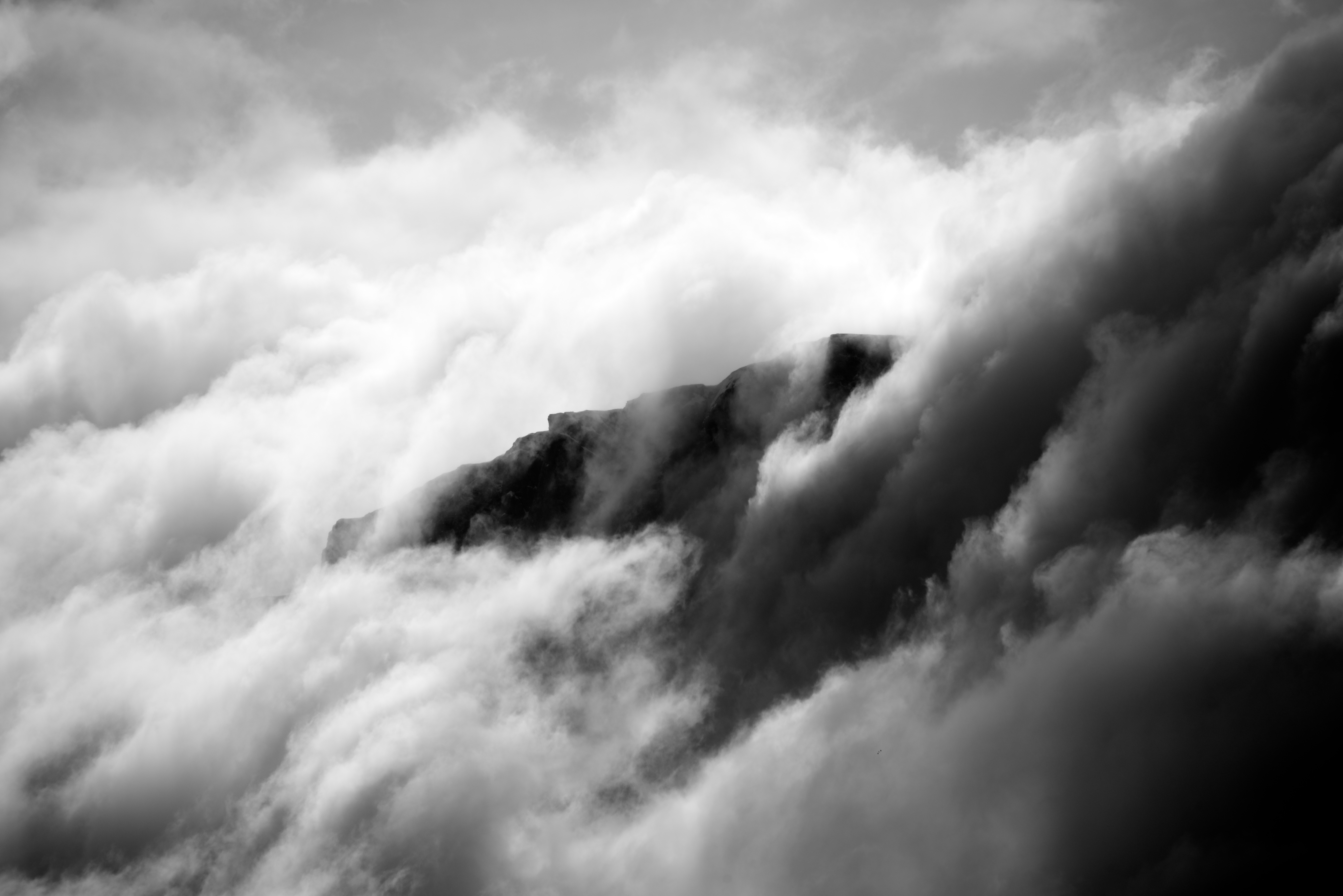 Black and white cliff appearing through clouds - Nick Dale - Private Tutor